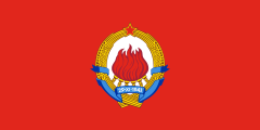 1963 proposed flag of Yugoslavia: red with the Yugoslavian emblem in the centre